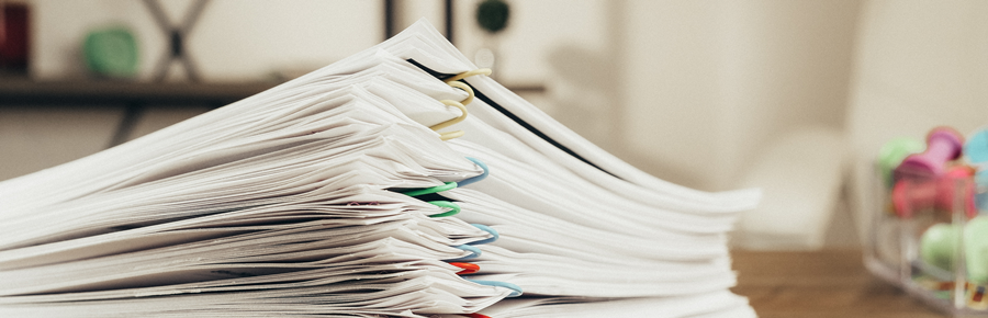 Picture of a stack of papers on a desk.